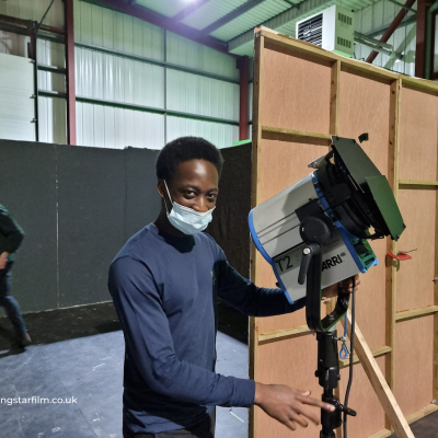 Michael Masvisvi, Cinematographer, rigs a light